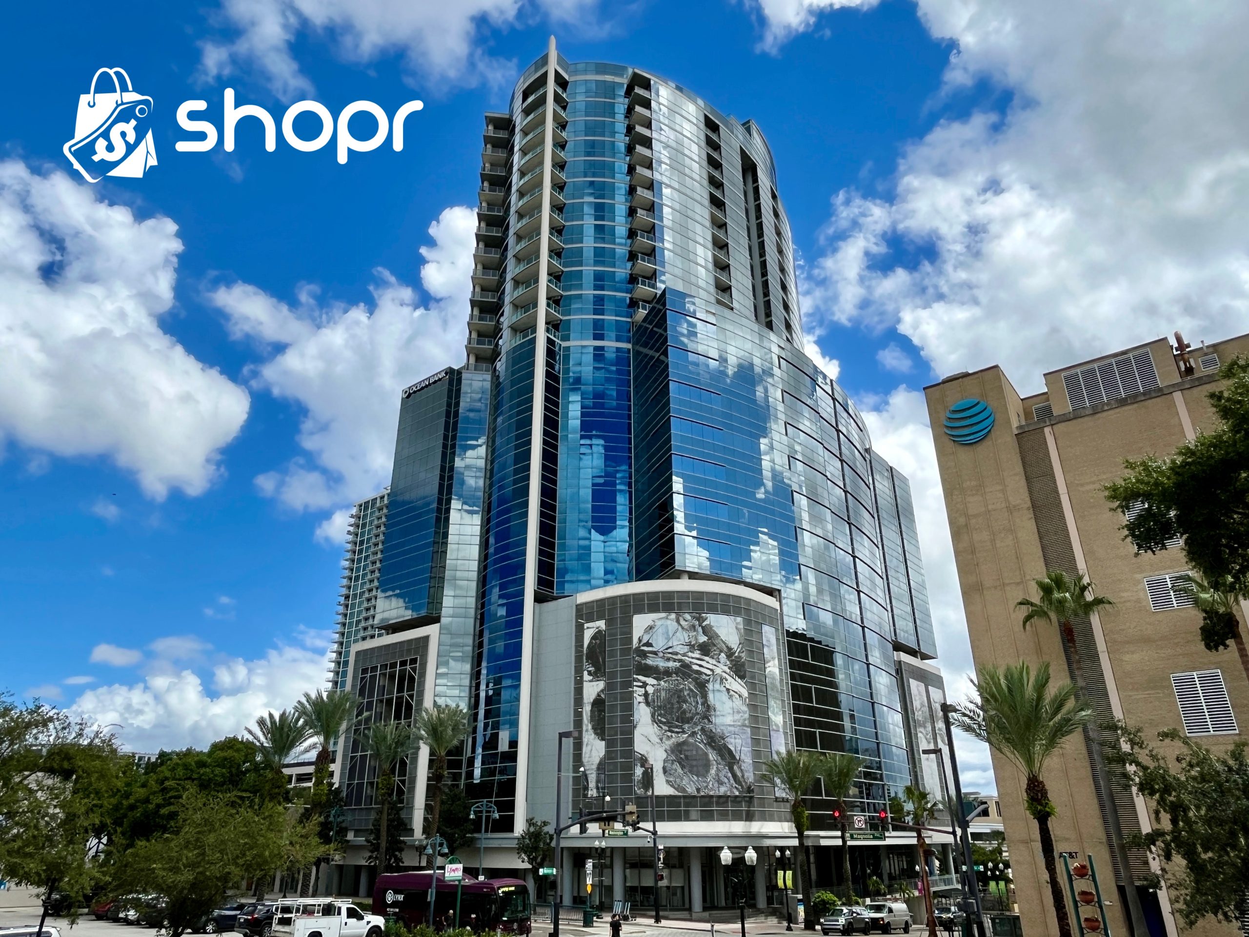 A photograph of the OneEleven building, a tall glass building in the heart of Downtown Orlando, which will be home to Shopr Rewards.